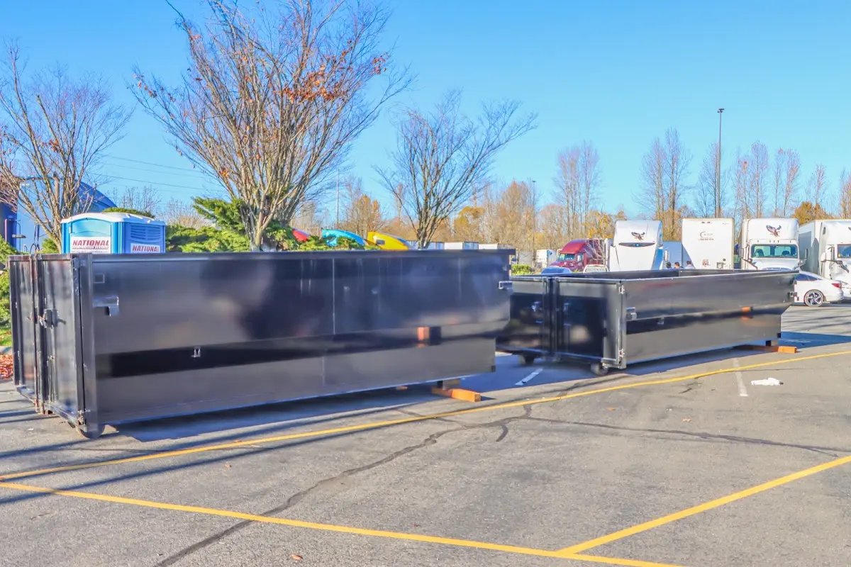 Professional dumpster rental service with roll-off container on residential driveway in Port Orange